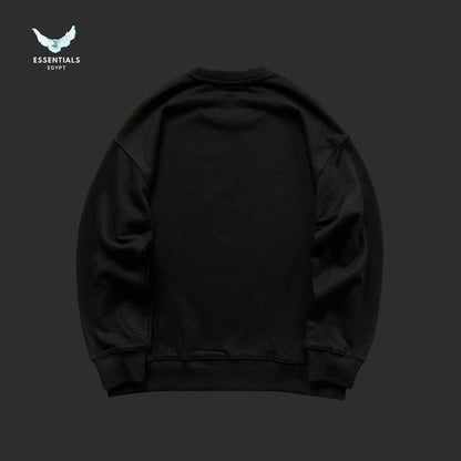 Black sweatshirt on a dark gray background with 'Essentials Egypt' logo.