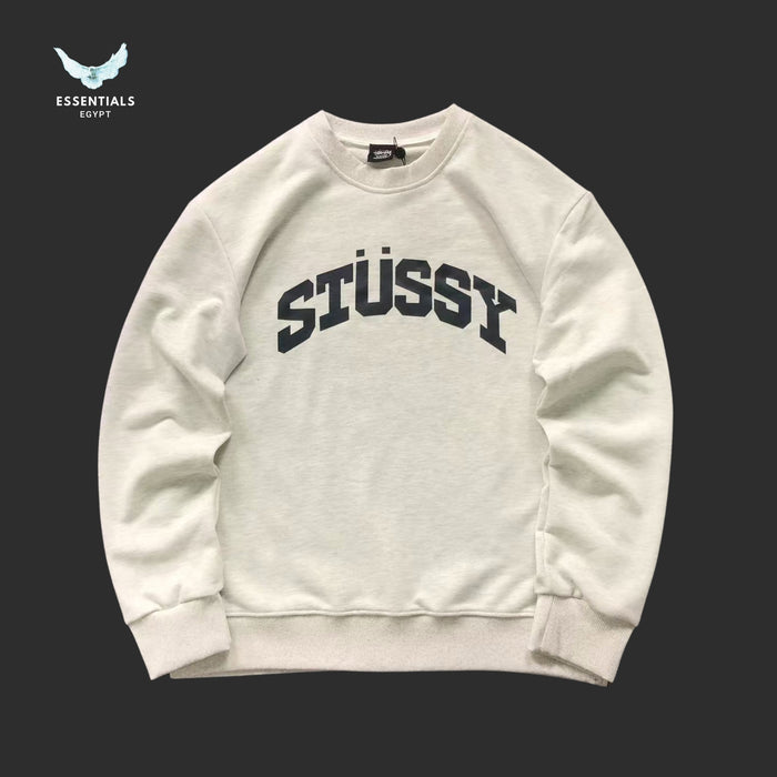 White Stussy sweatshirt on a black background