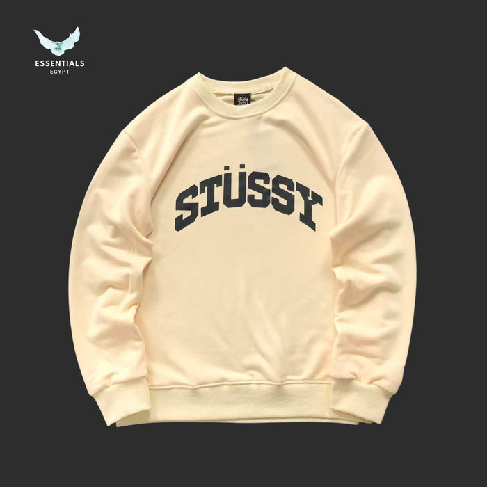 Beige Stussy sweatshirt on a black background