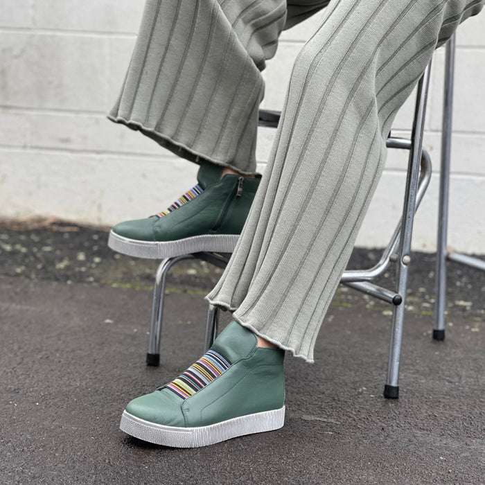 Forest green high-top sneakers with striped soles. Comfortable women's sneakers and boots.