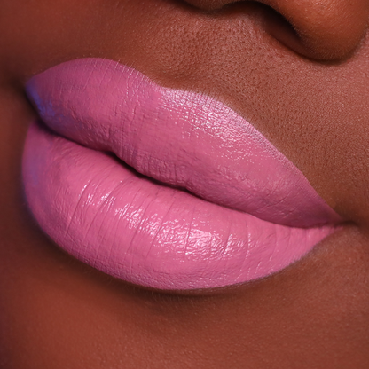 Tell Me More mauve pink lipstick on lips, deep skin tone close-up