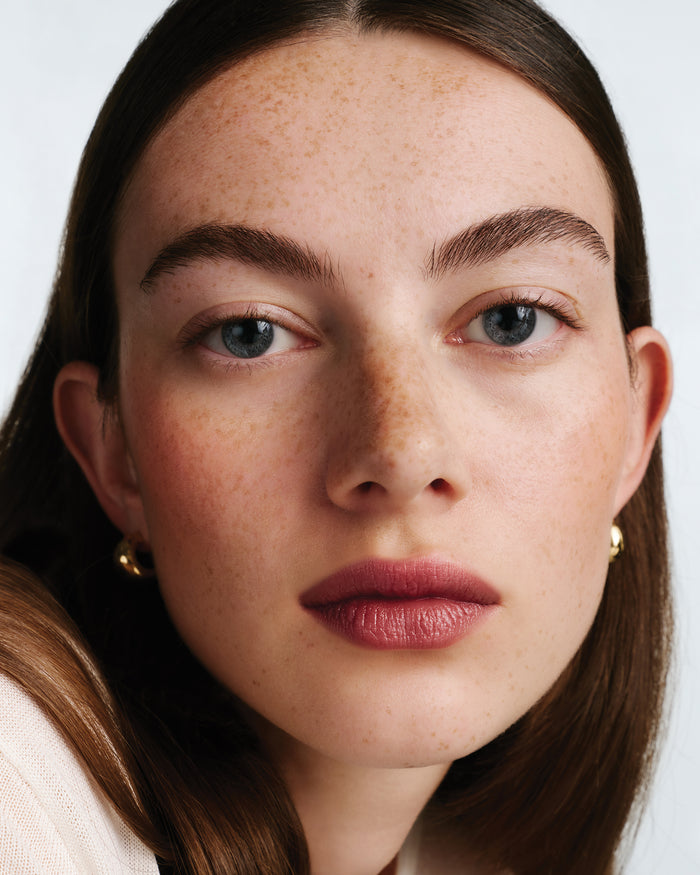 Close-up of a model wearing lipstick.