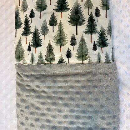 Fabric with tree pattern and gray pocket on a textured background