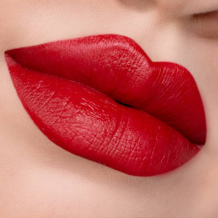 Velvet Matte You Red My Mind red lipstick on lips, light skin tone close-up