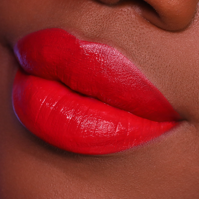 Velvet Matte You Red My Mind red lipstick on lips, deep skin tone close-up