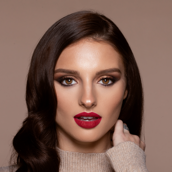 Model wearing Velvet Matte You Red My Mind red lipstick with a soft glam look